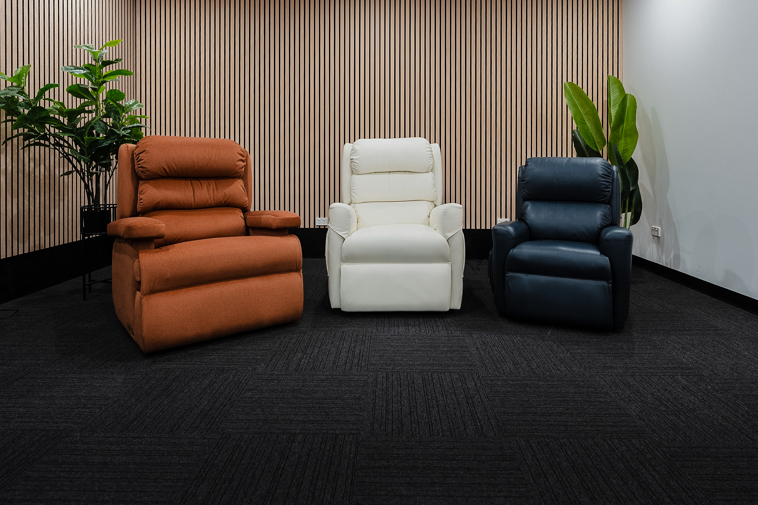 Orange, cream, and navy bariatric recliners displayed side by side