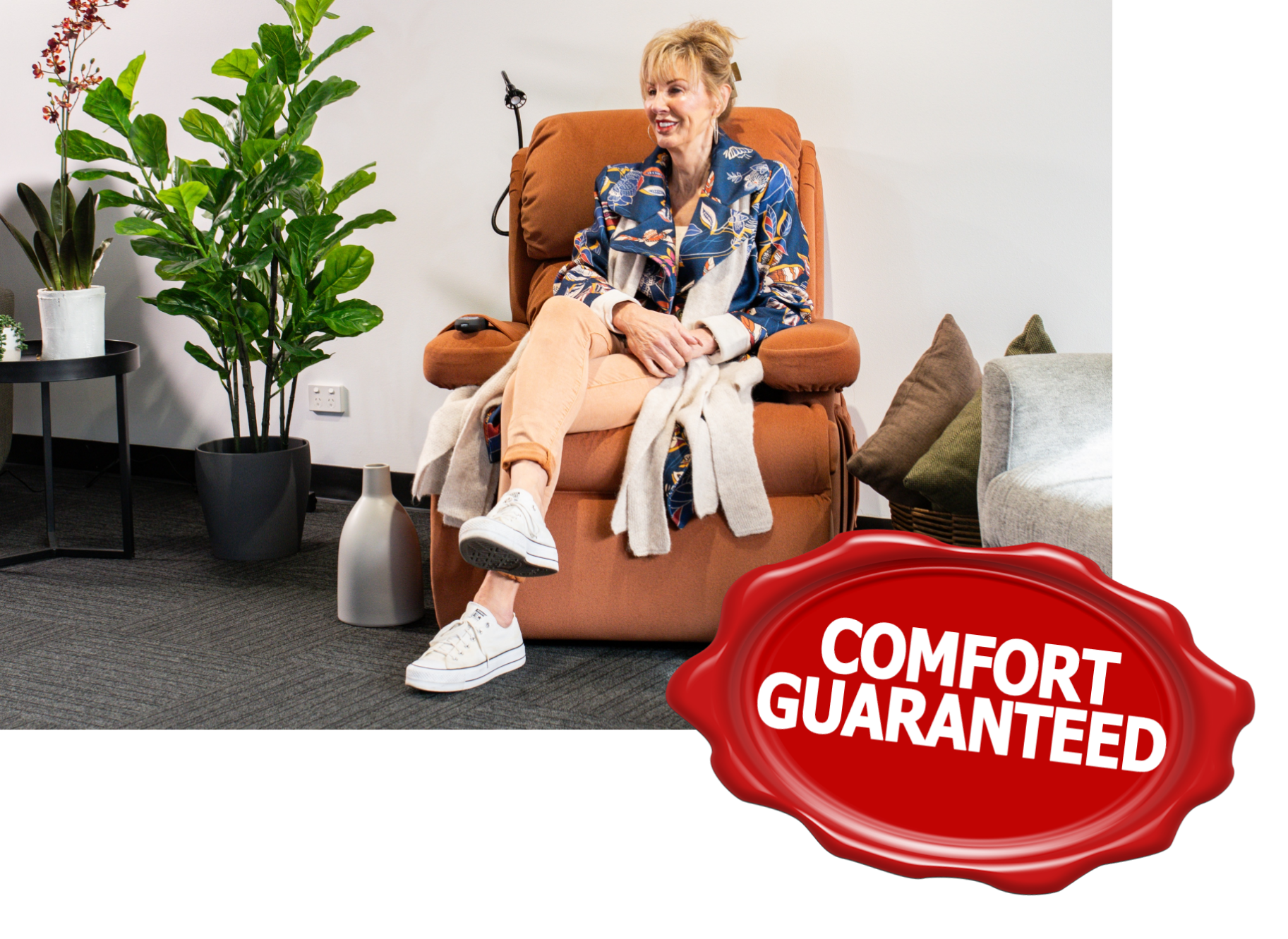 Woman relaxing in an orange recliner with a Comfort Guaranteed seal