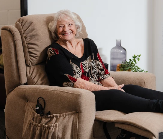 Smiling woman relaxing in her Posture Care recliner